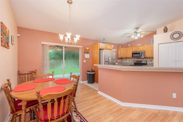 715 Unabelle Ave, Daytona Beach, FL 32117 - dining space with lofted ceiling, ceiling fan with notable chandelier, and light wood-type flooring