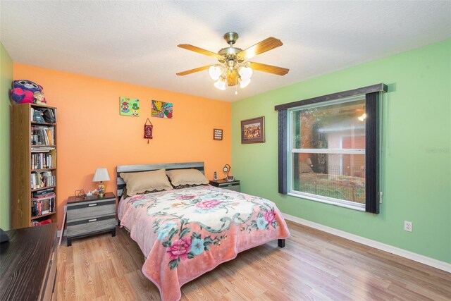 715 Unabelle Ave, Daytona Beach, FL 32117 - bedroom with ceiling fan, a textured ceiling, and light wood-type flooring