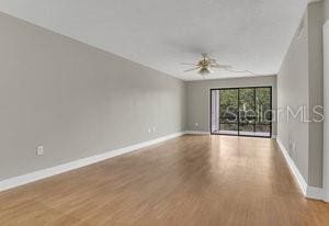 empty room with wood-type flooring and ceiling fan