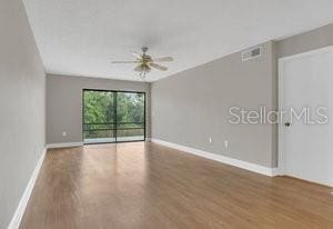 empty room featuring wood-type flooring and ceiling fan