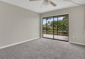 unfurnished room with carpet flooring and ceiling fan