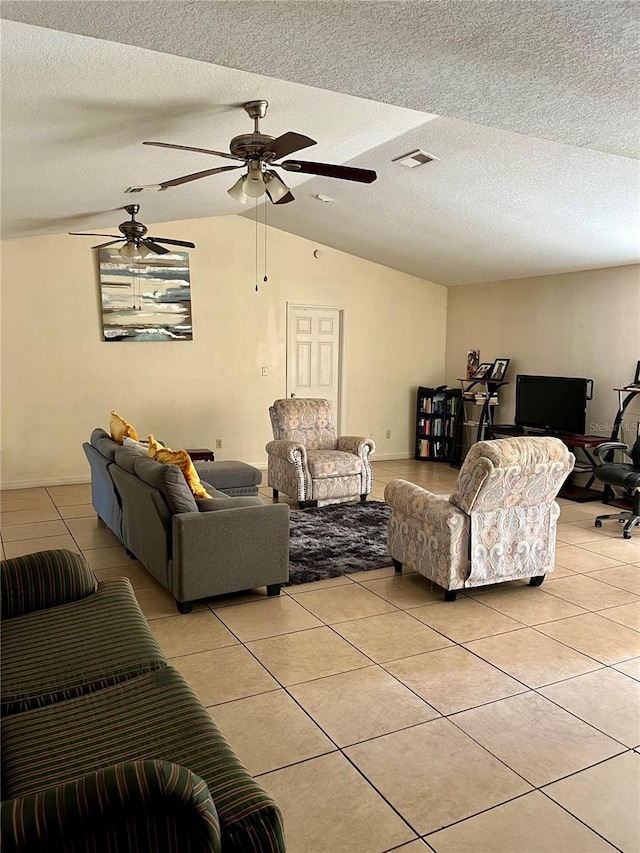 living room featuring a textured ceiling, ceiling fan, and lofted ceiling