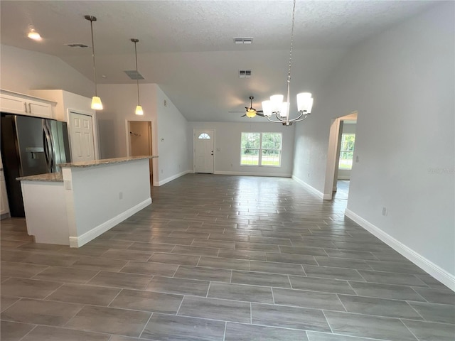 kitchen featuring a chandelier, a center island, stainless steel fridge with ice dispenser, open floor plan, and white cabinetry