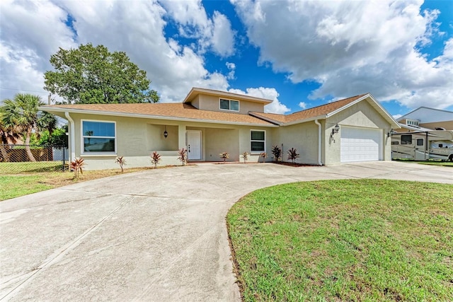 view of front of house with a garage and a front yard