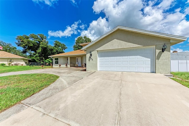 single story home with a garage and a front yard