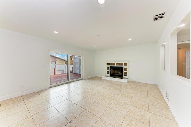 unfurnished living room featuring light tile patterned flooring and a fireplace