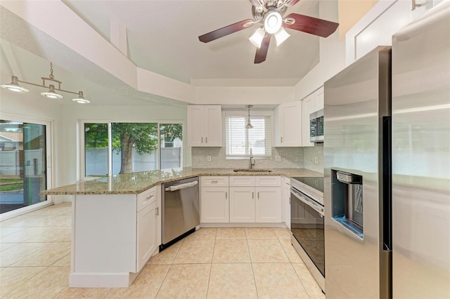 kitchen featuring decorative backsplash, white cabinets, sink, and stainless steel appliances