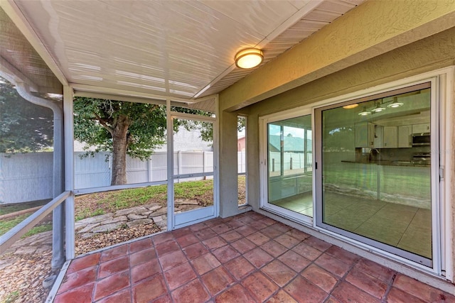 unfurnished sunroom featuring plenty of natural light and sink