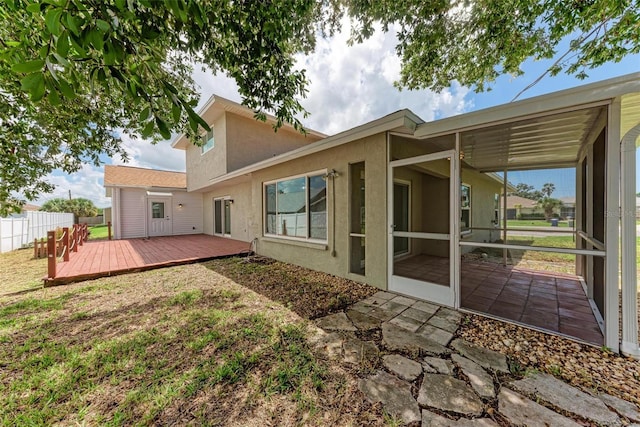 back of property featuring a deck