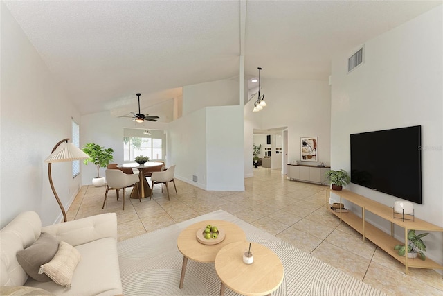 tiled living room with high vaulted ceiling and ceiling fan