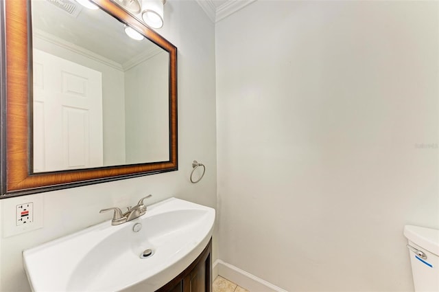 bathroom featuring tile patterned flooring, vanity, toilet, and ornamental molding