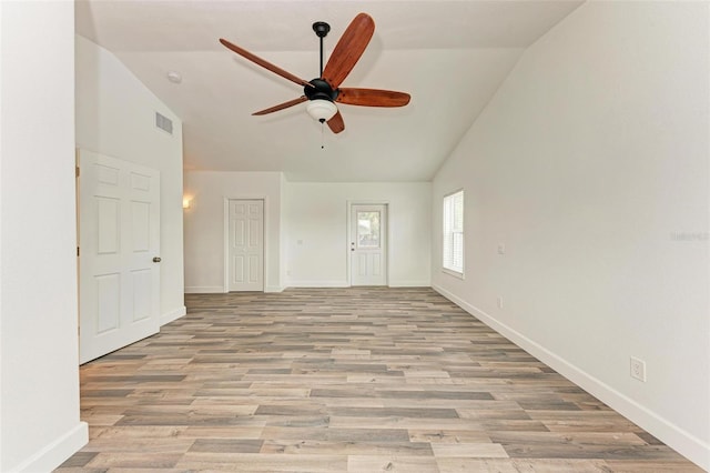 unfurnished living room featuring ceiling fan, vaulted ceiling, and light hardwood / wood-style floors