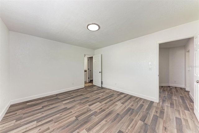 spare room with dark hardwood / wood-style floors