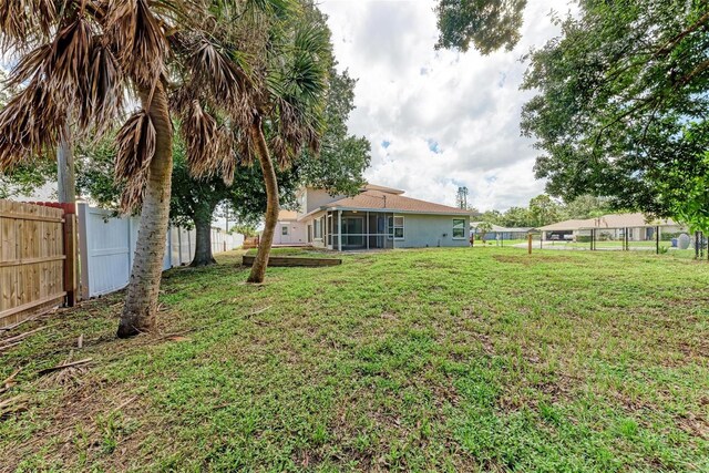 view of yard featuring a sunroom