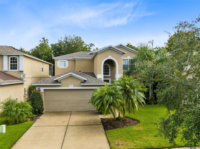 view of front of property featuring a garage and a front lawn