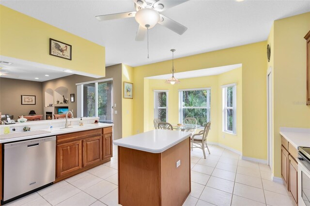 kitchen featuring decorative light fixtures, ceiling fan, stainless steel appliances, and plenty of natural light