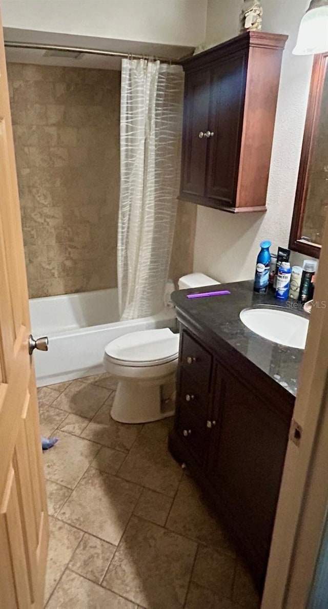 bathroom with toilet, vanity, and shower / bath combination with curtain