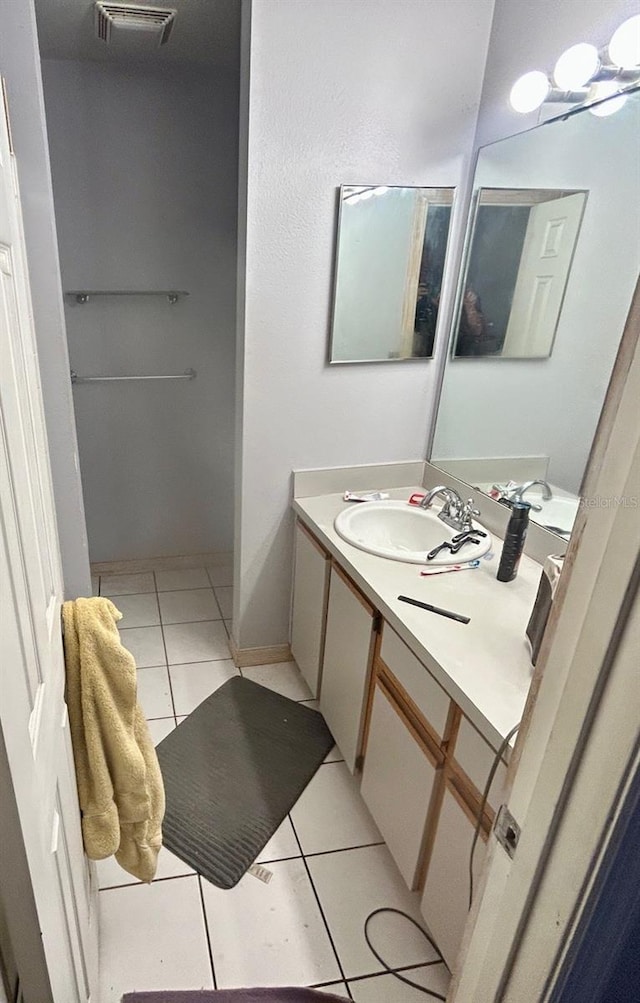 bathroom featuring visible vents, vanity, and tile patterned flooring