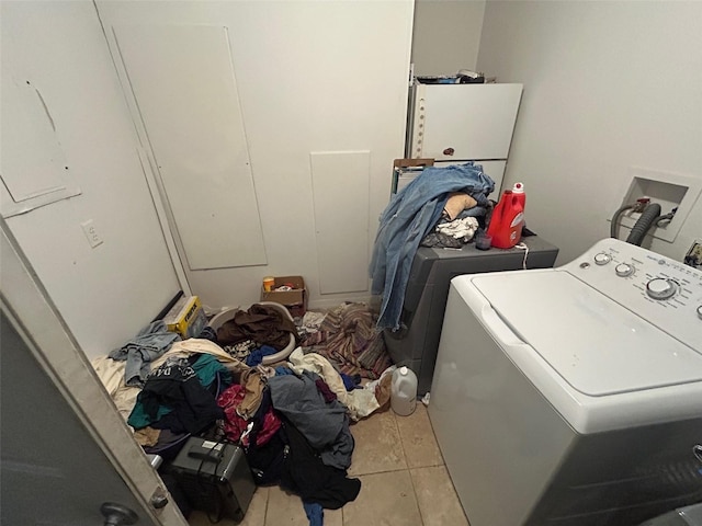 clothes washing area with tile patterned floors, laundry area, and separate washer and dryer