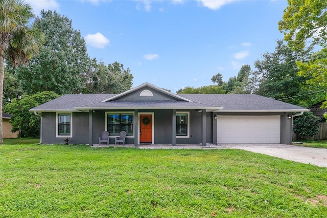 ranch-style house with covered porch, a garage, and a front lawn