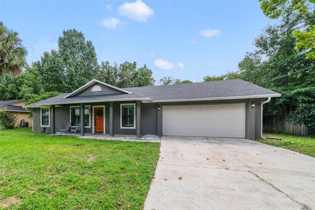 ranch-style home with fence, a front yard, stucco siding, driveway, and an attached garage