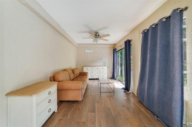 living room with wood finished floors and ceiling fan