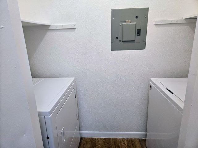 laundry room with electric panel, separate washer and dryer, and dark hardwood / wood-style floors