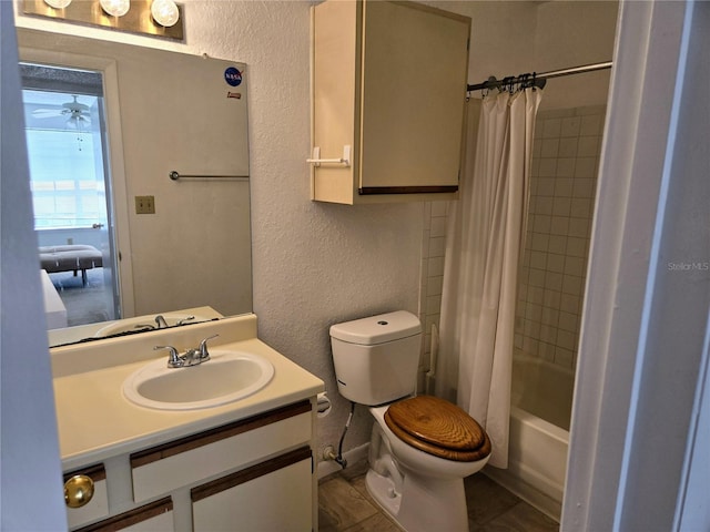 full bathroom featuring vanity, toilet, tile patterned floors, shower / bathtub combination with curtain, and ceiling fan