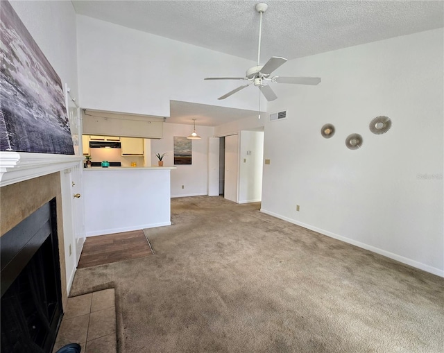 4401 Thornbriar Ln Unit 202, Orlando, FL 32822 - unfurnished living room featuring carpet, a tile fireplace, a ceiling fan, high vaulted ceiling, and baseboards