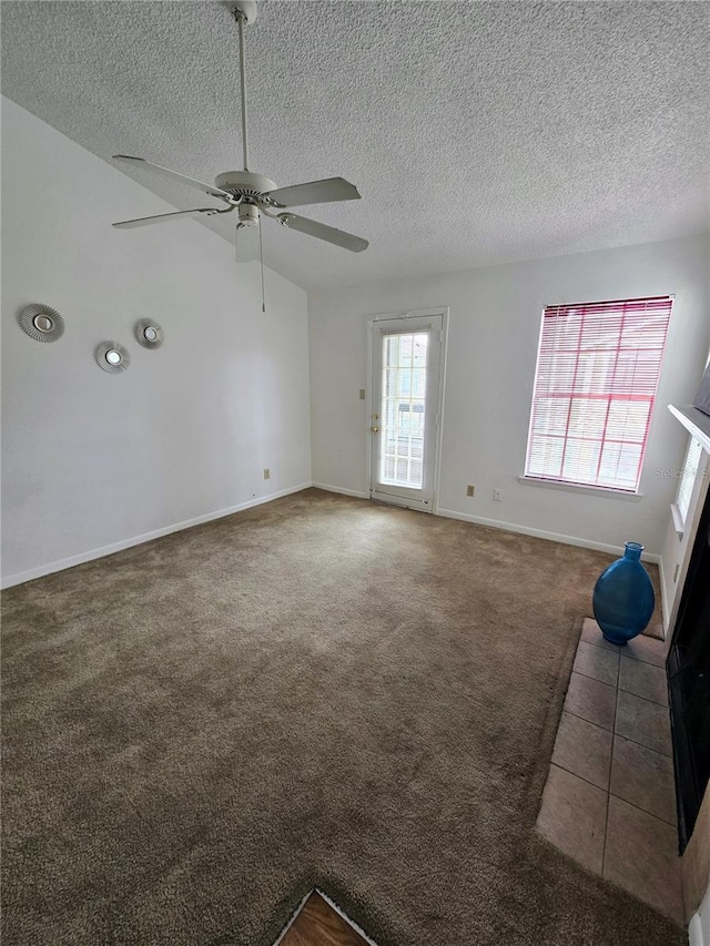 4401 Thornbriar Ln Unit 202, Orlando, FL 32822 - unfurnished living room with a ceiling fan, carpet flooring, a textured ceiling, baseboards, and a fireplace