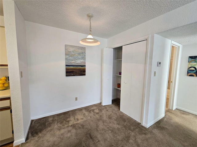4401 Thornbriar Ln Unit 202, Orlando, FL 32822 - unfurnished dining area featuring carpet, a textured ceiling, and baseboards