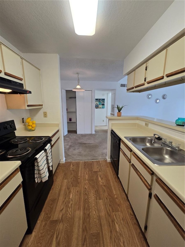 4401 Thornbriar Ln Unit 202, Orlando, FL 32822 - kitchen featuring black appliances, under cabinet range hood, a sink, dark wood finished floors, and a textured ceiling