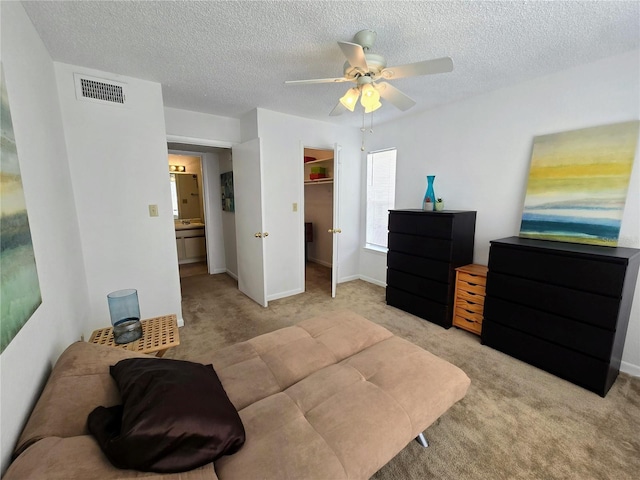 4401 Thornbriar Ln Unit 202, Orlando, FL 32822 - bedroom featuring light colored carpet, a textured ceiling, a spacious closet, a ceiling fan, and a closet