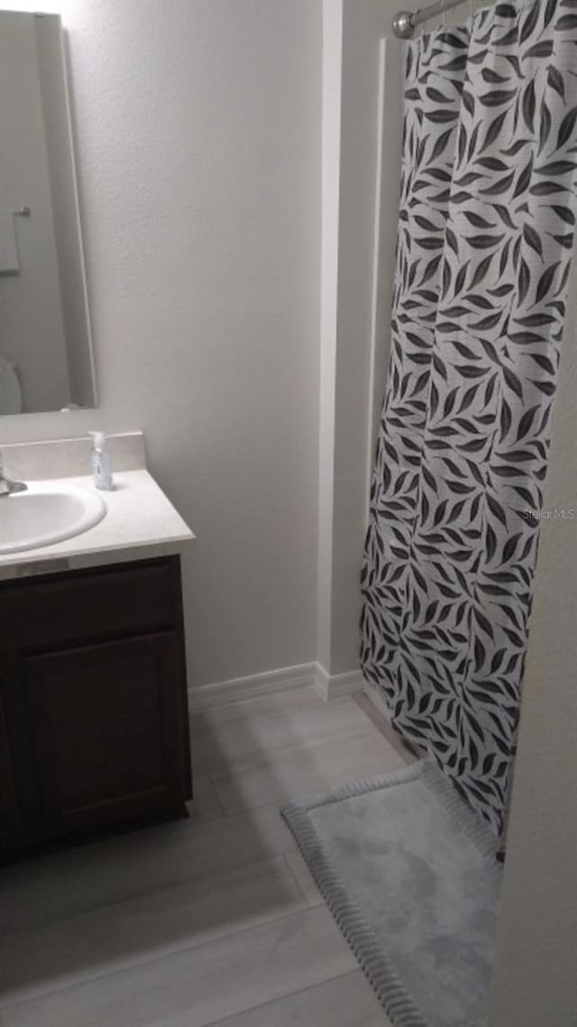 bathroom with vanity, tile patterned flooring, and a shower with shower curtain