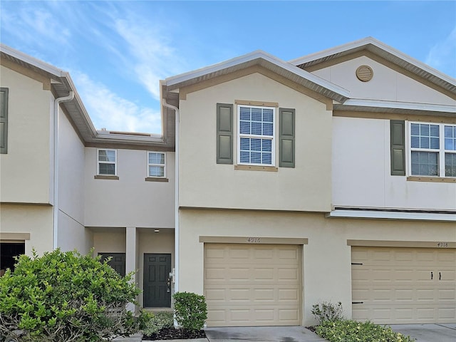 view of property with stucco siding and a garage