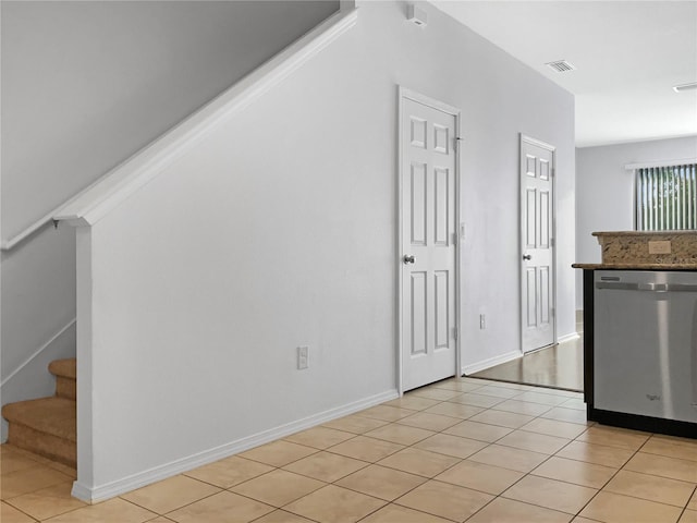 kitchen with light tile patterned floors, visible vents, baseboards, and dishwasher