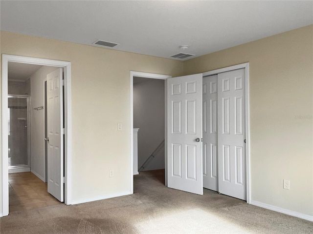 unfurnished bedroom featuring a closet, carpet flooring, and baseboards