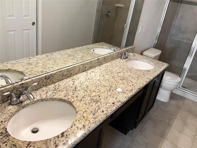 bathroom featuring tile patterned floors, walk in shower, toilet, and vanity