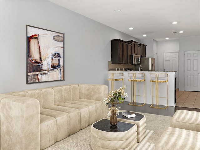 tiled living room featuring sink