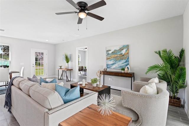 living room featuring ceiling fan and light hardwood / wood-style floors