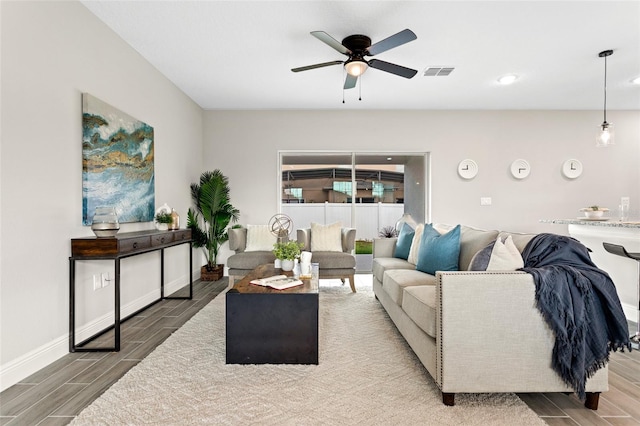 living room featuring hardwood / wood-style flooring and ceiling fan