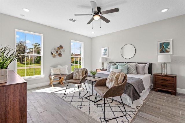 bedroom with light hardwood / wood-style flooring and ceiling fan