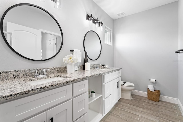 bathroom featuring vanity and toilet