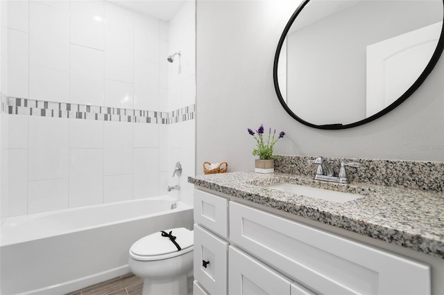 full bathroom featuring toilet, tiled shower / bath combo, hardwood / wood-style flooring, and vanity