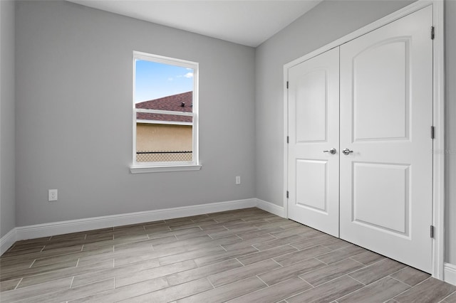 unfurnished bedroom featuring light wood-type flooring and a closet