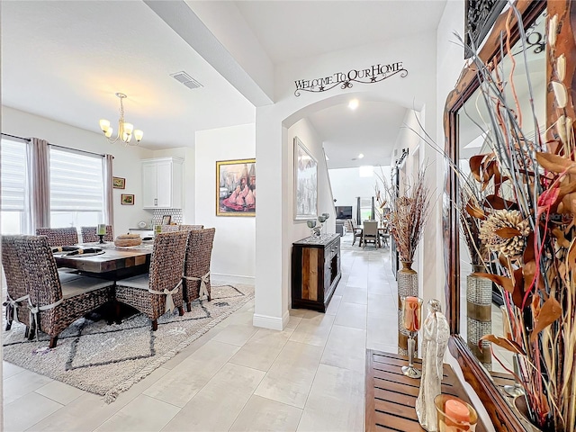 dining area featuring an inviting chandelier and light tile patterned floors