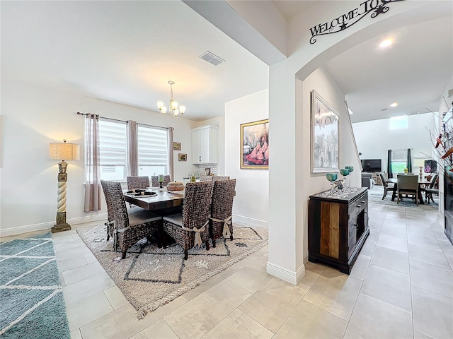 tiled dining area with a chandelier