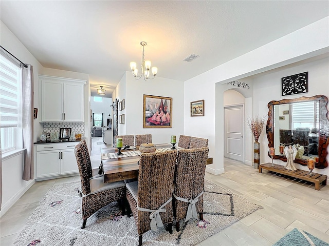 dining room with plenty of natural light and a chandelier