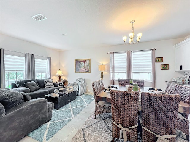 dining area with a notable chandelier and light tile patterned flooring