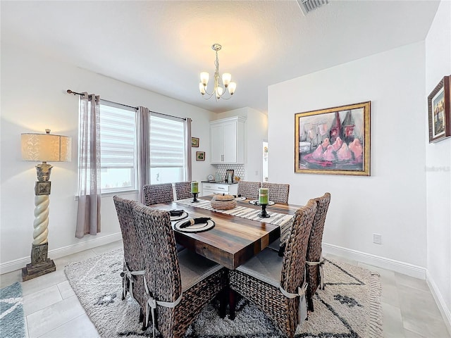 tiled dining area with a chandelier